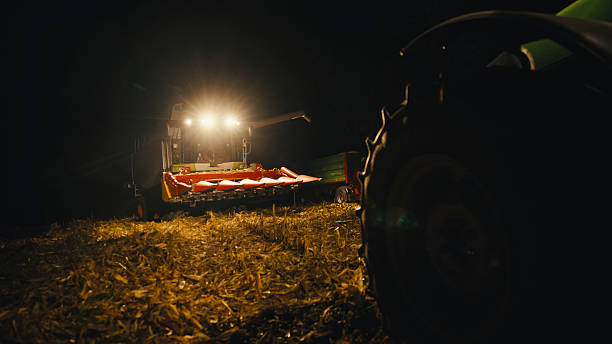 istock Combine Harvester Transferring Corn to Grain Truck Under Night Sky Glow 2246149777