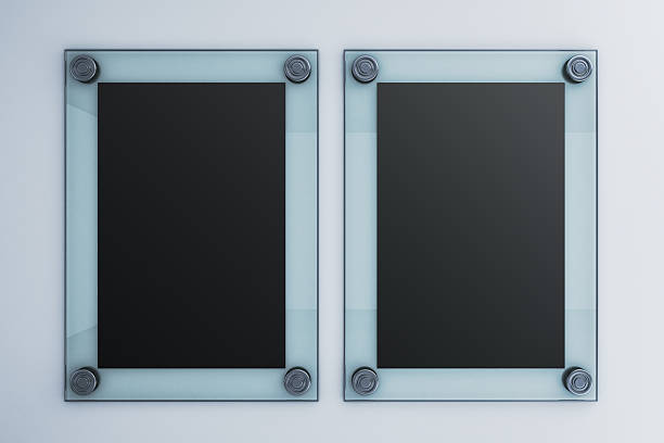 Two vertical black blank glass signage boards with metallic screws, clean modern style, on light wall background for poster or display mockup. 3D Rendering