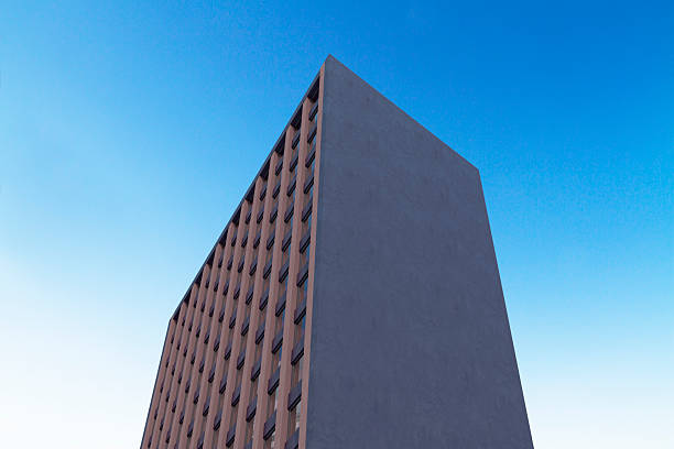 istock Modern building with large blank facade against clear blue sky, ideal for outdoor billboard mockup or branding design presentation template. 3D Rendering 2246150321