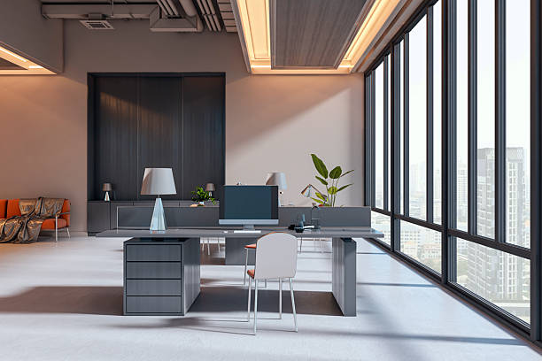istock Modern corporate office interior with stylish desk, large windows, and warm lighting in high-rise building city view background. 3D Rendering 2246150337