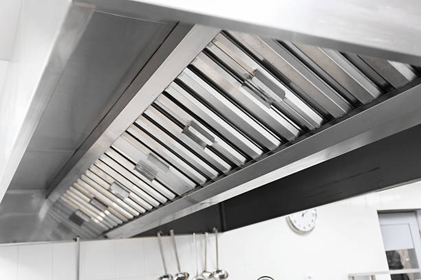 istock Kitchen exhaust hood above stainless steel work area in a commercial kitchen setting 2246150515