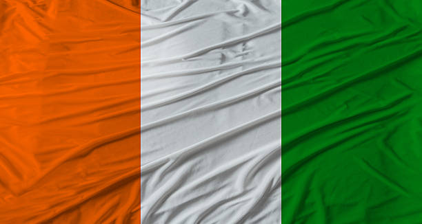 istock Ivorian flag waving. Flag of Ivory Coast with cloth texture 2246152433