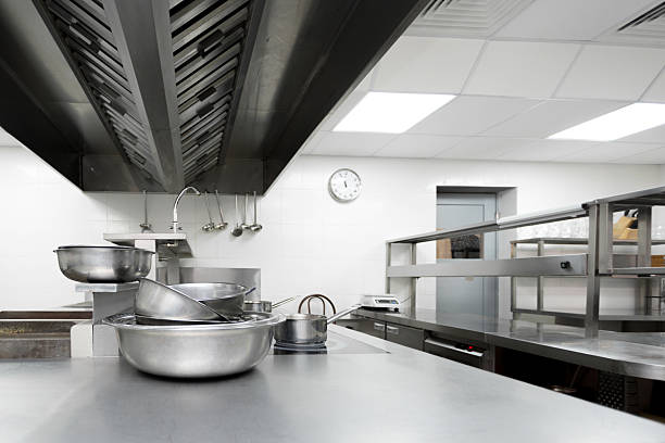 istock Busy commercial kitchen equipped with stainless steel counters and appliances during afternoon hours 2246152484