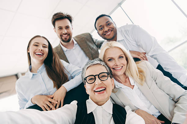 istock Diverse group of professionals smiling together in a modern office environment representing collaboration and teamwork 2246153324