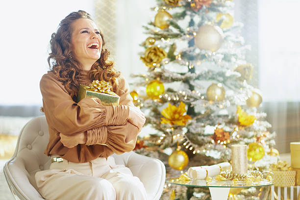 istock Blissful Laughter with a Golden Christmas Gift 2246153333