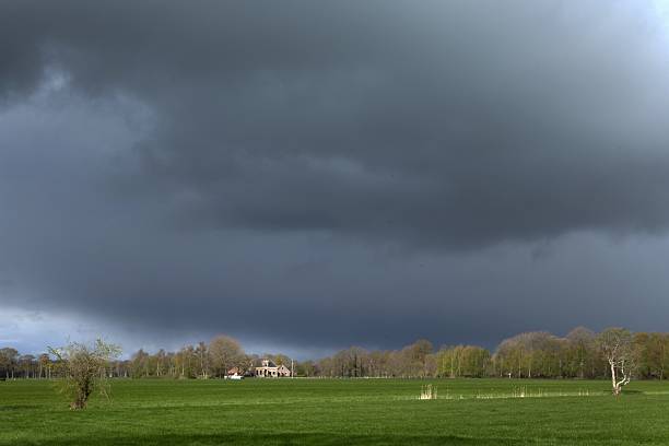 Rural scenes at Broekhuizen Ruinerwold. Dark rain clouds over green meadows