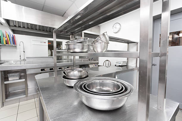 istock Stainless steel bowls and kitchen equipment in modern cooking space 2246155412