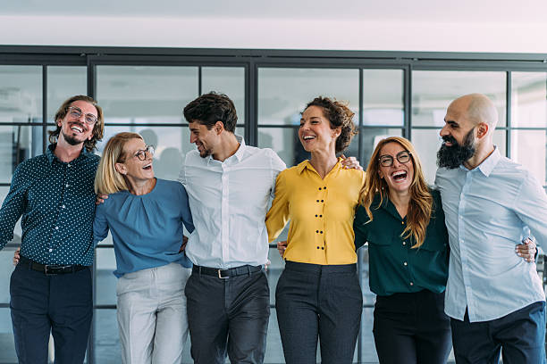 istock Excited coworkers embracing each other during a celebration in the office. 2246155491