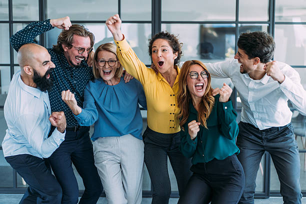 istock Cheerful entrepreneurs celebrating success in the office. 2246155498