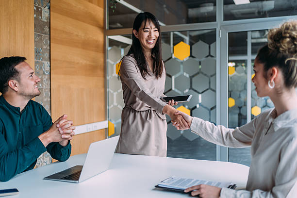 istock Businesspeople shaking hands across the table. 2246155917