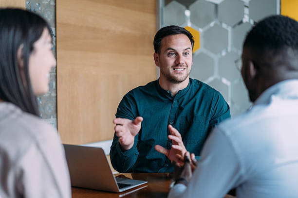 istock Group of businesspeople talking in the office. 2246155922