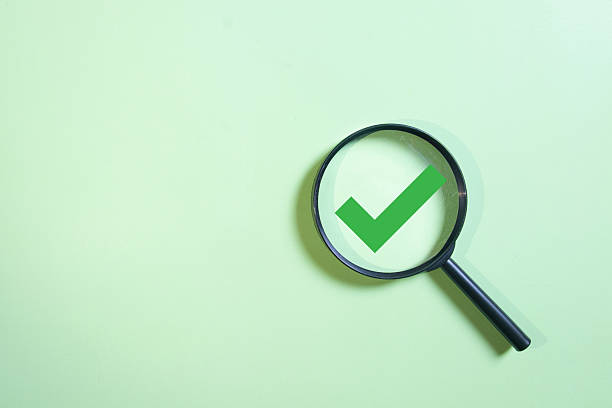 istock Magnifying glass focusing on green check mark icon. 2246156416
