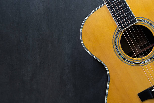 istock old acoustic guitar on black table background, music concept 2246159398