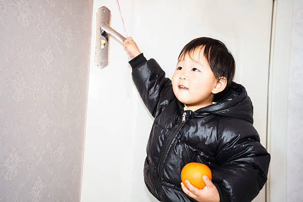 A one-year-old Asian girl playing alone at home