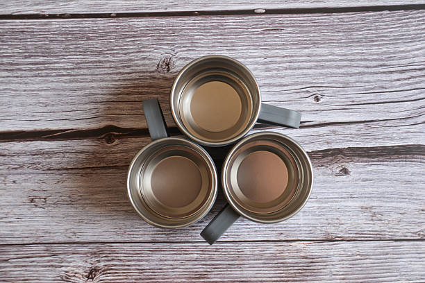istock Coffee mug on a wooden table. Empty cup on wooden background. Metal cup 2246160064