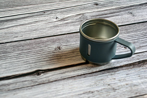 istock Coffee mug on a wooden table. Empty cup on wooden background. Metal cup 2246160136