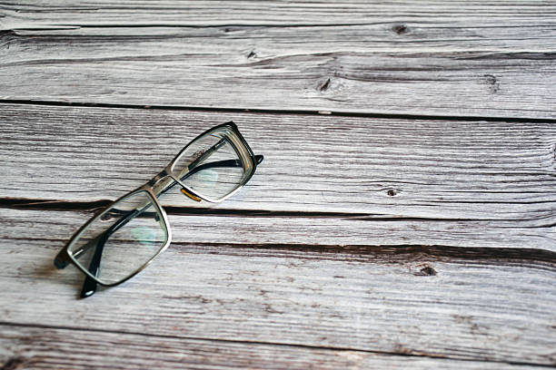 Optical glasses. Eyeglasses on a wooden table. Myopia glasses with frame