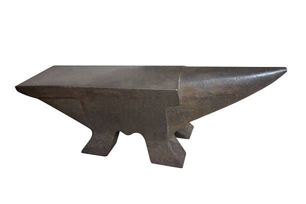 Blacksmith works on a glowing horseshoe on the anvil