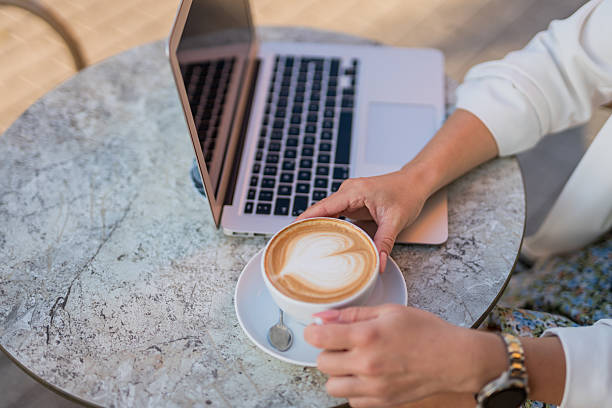istock Close-up woman  working remotely during coffee break at cafe 2246163529