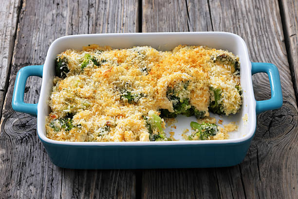 A hearty casserole filled with chicken fillet, broccoli, and creamy garlic sour cream is plated neatly. This dish is perfect for a comforting meal at home, enjoyed any time of day.