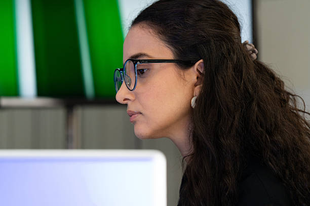 istock Focused businesswoman working on computer in modern office. Professional female analyzing data and concentrating on project tasks, representing productivity, technology, and corporate success. 2246166521