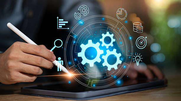 istock A businessman using a digital tablet with glowing gear icons, representing workflow automation, business process management, innovation, and efficiency powered by modern digital technology. 2246167064