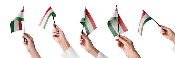 The Tajikistan flag in hand in different angles on a white background.