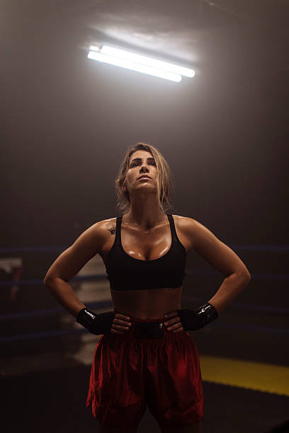 istock Determined Female Boxer Stands Strong in Ring Under Bright Overhead Light 2246167263