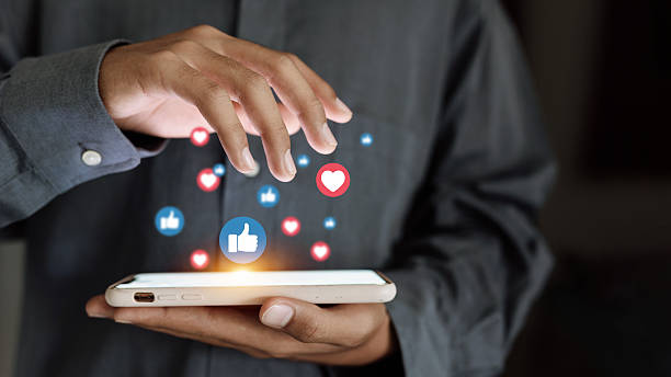 istock Hand using smartphone with floating social media icons, digital marketing and communication concept 2246167595