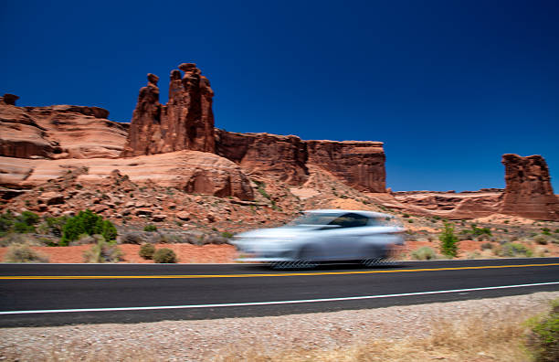 istock Vehicles driving fast through Arches National Park with iconic sandstone formations around 2246169346
