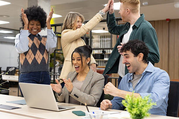 istock Diverse business team celebrating success at office 2246169542