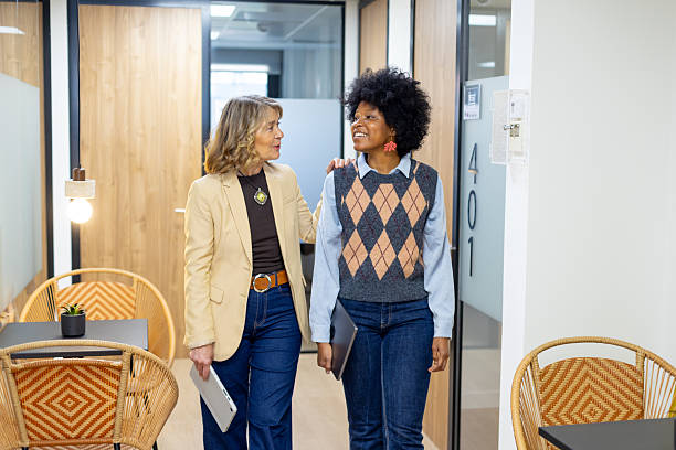 istock Diverse women coworkers walking and having a conversation 2246169569