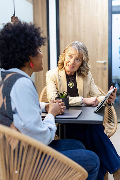 istock Businesswomen discussing during meeting in modern office 2246169582