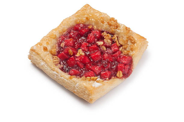 Colorful fruit pastries are arranged neatly, showcasing a variety of toppings like pineapple, kiwi, and cherries.