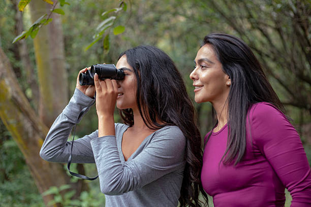 istock Hispanic mother and daughter on hike using binoculars 2246170137