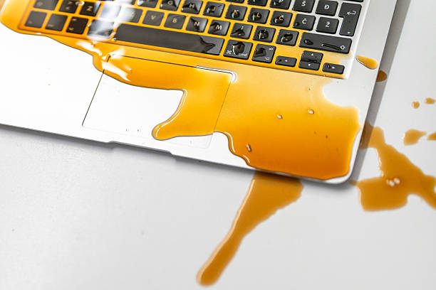 istock Unfortunate Coffee Spill Covering Laptop Keyboard on White Desk Surface 2246171992
