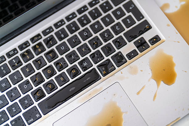 istock Messy Liquid Accident Covering Keyboard and Touchpad on Laptop in Office Setting 2246172001