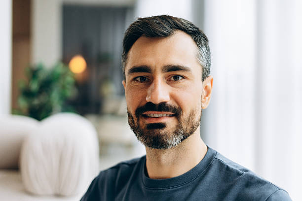 istock Smiling bearded man looking at camera indoors 2246174263