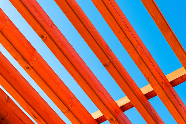 abstract pattern of red wooden boards against a blue sky architectural background