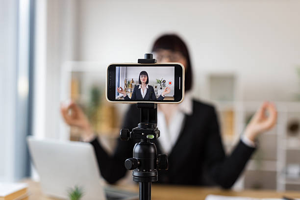 istock Caucasian Businesswoman Recording Meditation While Multi-Tasking at Work Desk 2246178428