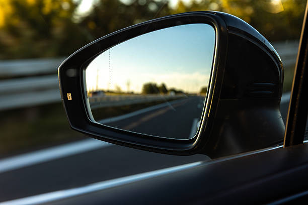 istock Road reflection in car mirror. Journey through drivers eyes. 2246178566