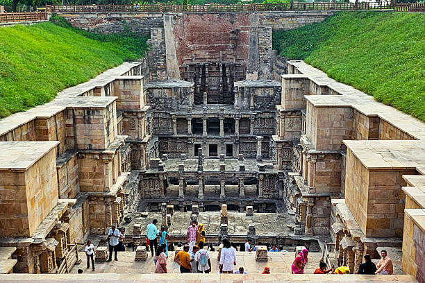 Patan, Gujarat, India - 21 July, 2024: Rani Ki Vav, the ancient stepwell of Patan, Gujarat, India, is a masterpiece of Indian architecture and engineering. Featuring intricately carved sandstone pillars, sculptures, and descending stairways, this UNESCO World Heritage Site reflects the grandeur of ancient craftsmanship and cultural heritage. Tourists explore its deep atrium surrounded by ornate stonework and historic artistry, making it a must-visit destination for travel, history, and architecture enthusiasts.