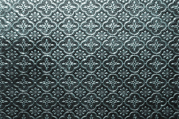 istock Ornamental patterned glass surface with embossed floral motifs and metallic tone 2246182826
