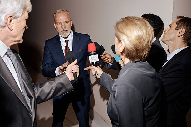 istock Middle Aged Caucasian Man Answering Questions from Journalists at Press Event 2246183241