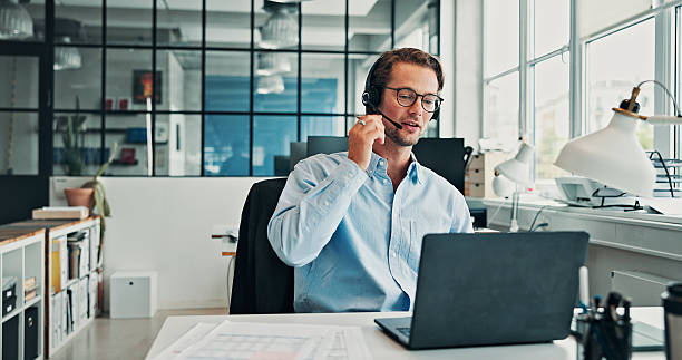 istock Finance, headset and laptop with business man at desk in office for feedback or virtual support. Computer, communication and consulting with financial advisor in workplace for customer service 2246184230