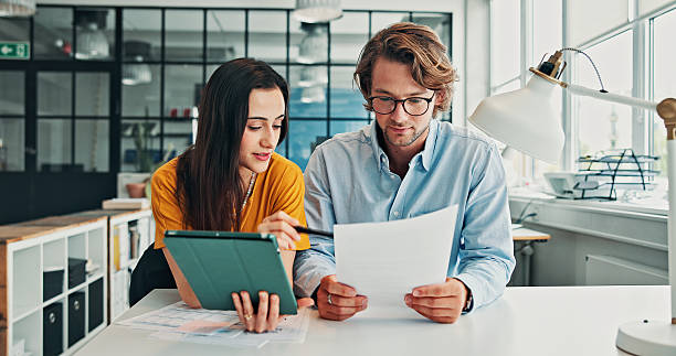 istock Review, document or people in office with tablet, partnership or reading of financial statement. Collaboration, audit paper or analyst in agency with tech, finance report or data entry on online app. 2246184415