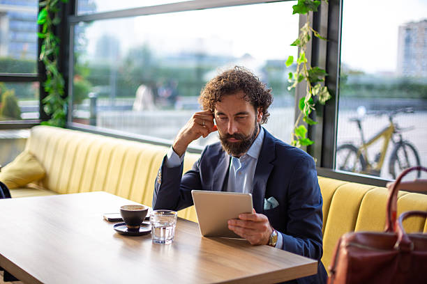 istock Businessman working on digital tablet in cafe 2246184961