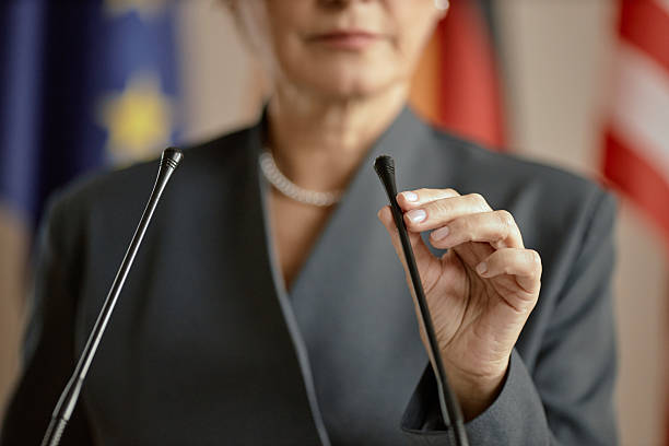 istock Middle Aged Caucasian Woman Adjusting Microphone before Giving Speech 2246191470
