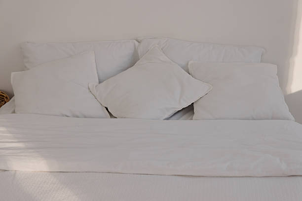 istock Clean White Bedding and Pillows in Minimalist Bedroom Design 2246192237