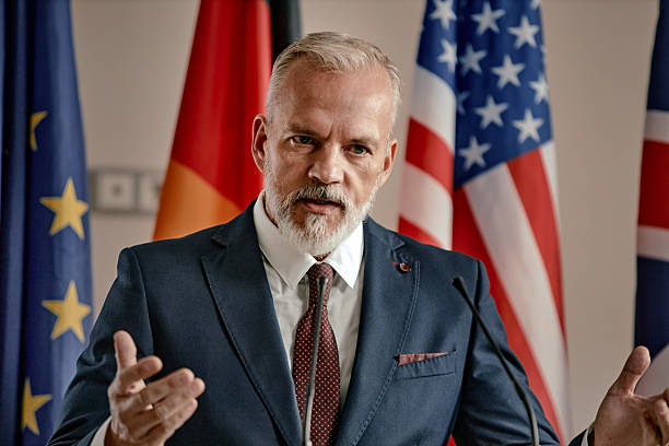 istock Caucasian Middle Aged Man Speaking at Podium during International Conference 2246192319